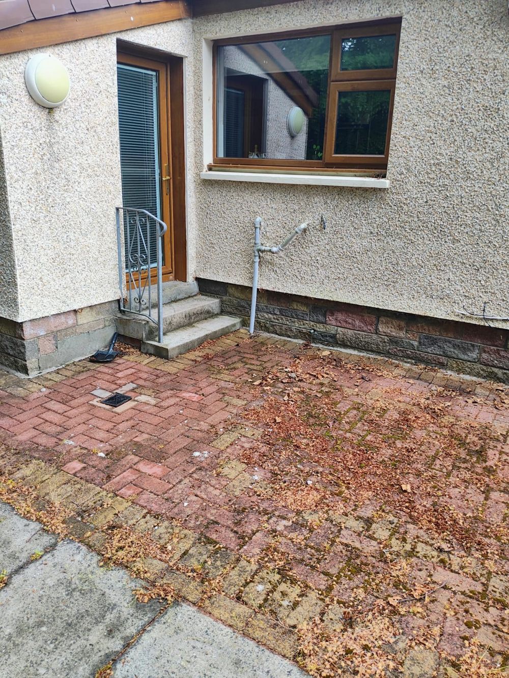 Before: the rear doorway and original step above the block paving.